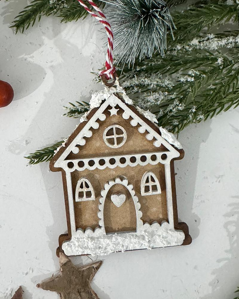 MDF Gingerbread House Bauble Pack - Wood Blank Craft Kit, Home Décor, Christmas ornament with snowy details and a red and white string, hanging from a Christmas tree branch.