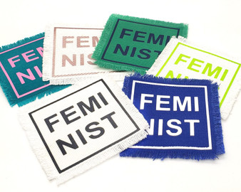 Feminist square iron on patches in various color combinations.