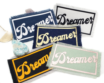 Dreamer iron on patches in various color combinations.