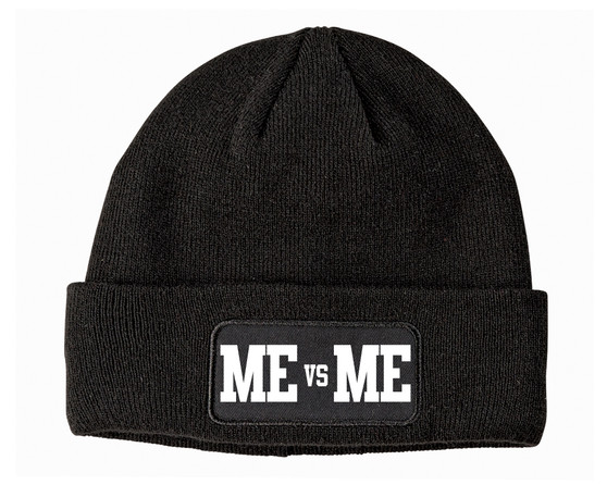 Black beanie with a front patch that says Me vs Me in white.