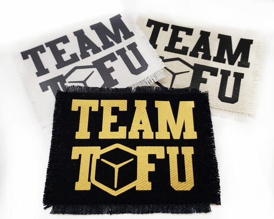 Team Tofu iron on patch in black and 24K gold metallic.