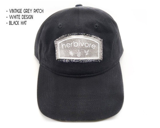 Black dad hat with vintage grey and white herbivore patch.