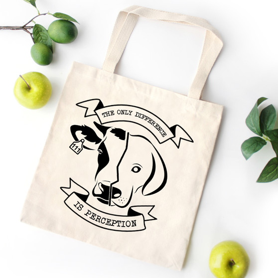 Natural canvas vegan tote showing half of a cow's face and half of a dog's face and the words the only difference is perception printed on it.