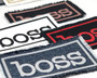 Iron on patches with the word boss on it in a variety of colors.