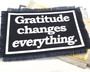 Iron on patches in various colors with the words Gratitude Changes Everything.