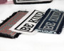 Denim iron on patches in various colors with the words "Be Kind" on them.