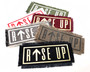 Iron on patches with the words rise up including an arrow pointing up.