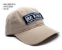 Tan unstructured dad hat with be kind patch.