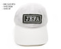 Front view of white dad hat with jefa patch.