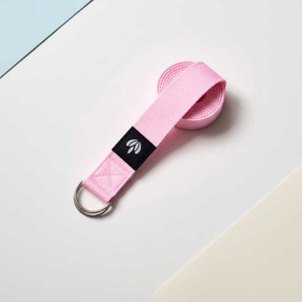 Pink cotton D-ring yoga strap for stretching and flexibility training.