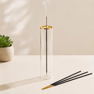 Modern glass incense burner with gold lid, enclosed ash catcher and vertical incense stick for meditation, yoga and home décor.