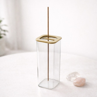 minimalist glass incense burner with gold lid and crystals