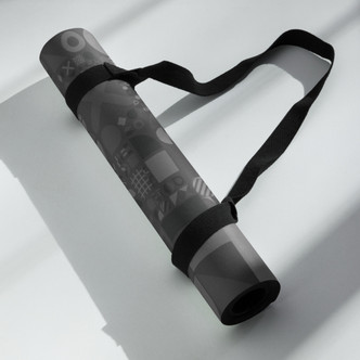 Rolled Geo Zen yoga mat secured with a black carry strap for easy transport
