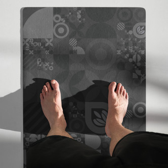 Top-down view of the Geo Zen yoga mat showing its black and grey geometric design