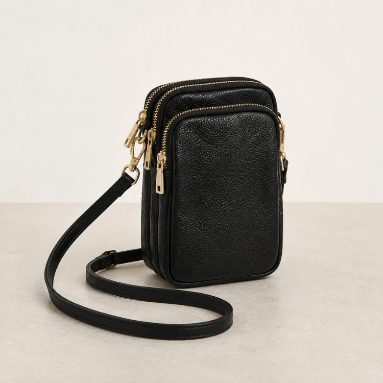 Compact black vegan leather crossbody phone bag with adjustable strap