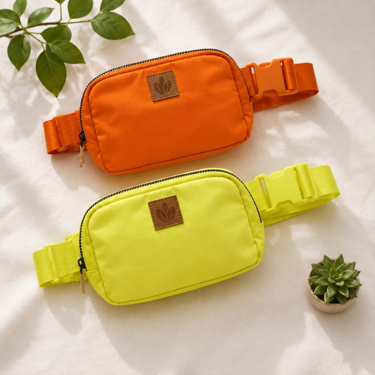 Orange and neon yellow lightweight waist bags with adjustable straps and zip compartments displayed on a neutral background