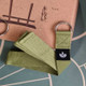 Green cotton yoga strap supporting seated stretching exercises.