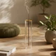 Minimalist glass incense burner creating a calm atmosphere in a modern meditation and yoga space with soft natural lighting.