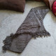 Charcoal knit meditation blanket with woven tassel fringe
