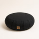 Black meditation zafu cushion with carrying handle for comfortable meditation and mindful seating