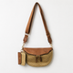 Brown leather and straw woven crossbody waist bag with adjustable shoulder strap and matching coin pouch