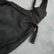 Black nylon shoulder bag close up of zip detail