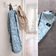 Sky blue yoga mat bag hanging on hook in home