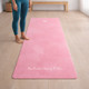 Woman standing on Rose Pink yoga mat in a bright home workout yoga setup, non-slip fitness mat for daily practice