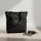 minimalist black tote bag on bench in a clean indoor setting