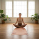 Person meditating on the Compact Love and Life pink suede TPE yoga mat in a bright studio.