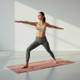 Person practising yoga on the Deco natural rubber yoga mat with non-slip microfibre suede surface.