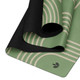 Close-up of the green Deco yoga mat showing the printed microfibre suede surface and black natural rubber base