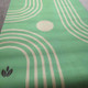 Rolled Deco green yoga mat design made from natural rubber with a soft microfibre suede finish.