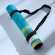 Retro Pathway yoga mat rolled and secured with a black carry strap for easy transport