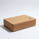 Rectangular high-density cork yoga block with rounded edges.