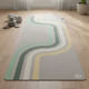 Neutral retro stripe yoga mat with green, cream and yellow curved design displayed on a light wooden floor