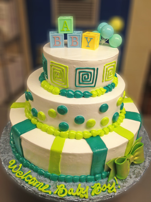 Approximate Servings 80. Sizes: 7", 10" & 14". Sugar flowers, sugar baby showed and sugar bow adorn this pearled three tiered cake.