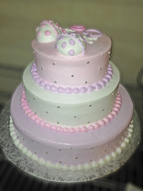 Approximate Servings 80. Sizes: 7", 10" & 14". Three tiered rattle topped cake with silver NON EDIBLE pearls all around.