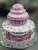 This a 7" tall cupcake on top of 12" cake.  The entire creation is sculpted only with cake and frosting.  Your banner will have any text you desire!