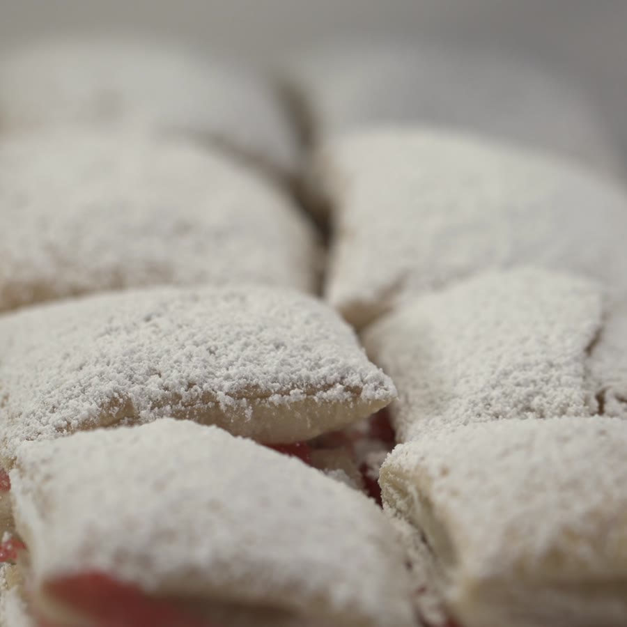 Guava pastelitos dusted with powdered sugar