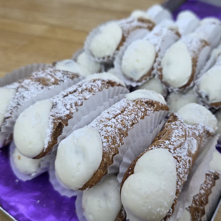 Small cannoli dusted with powdered sugar