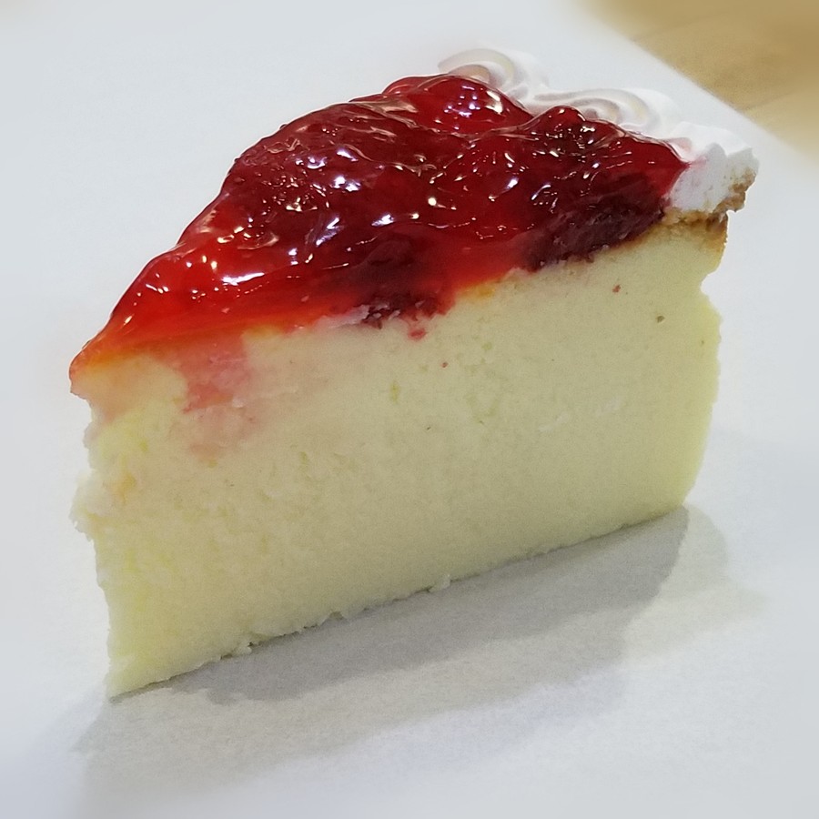 A slice of strawberry cheesecake
