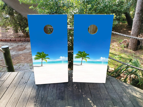 cornhole boards featuring white sands and a palm tree