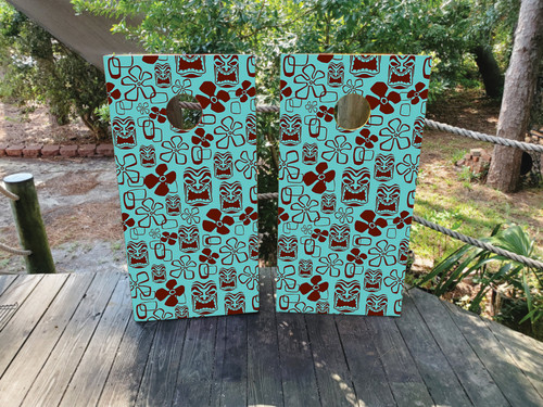 "Blue and Maroon Tiki Cornhole Boards featuring tropical tiki mask design with vibrant island colors and beach theme"