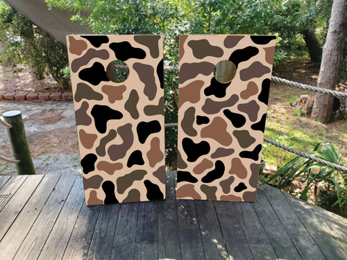 Custom camouflage cornhole boards featuring a military-inspired pattern in shades of tan, green, brown, and black. The bold camo design creates a rugged and outdoorsy look, perfect for hunting trips, backyard gatherings, military events, and outdoor parties.