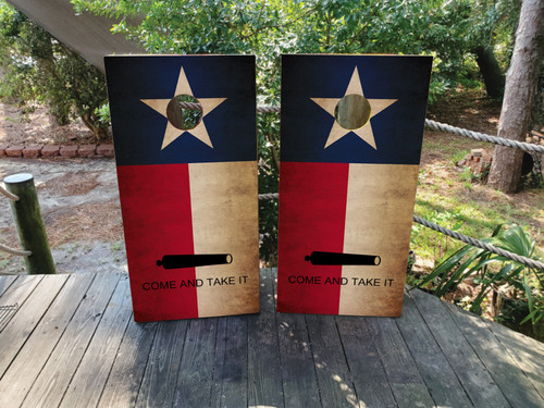 Cornhole boards featuring a distressed TX flag that says "come and take it"