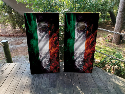 Irish flag-themed cornhole board wraps with wavy smoke design in green, white, and orange, displayed outdoors on wooden decking.