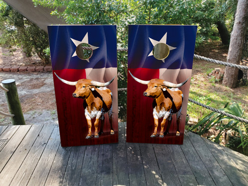 Cornhole boards featuring a waving Texas flag and a longhorn cattle