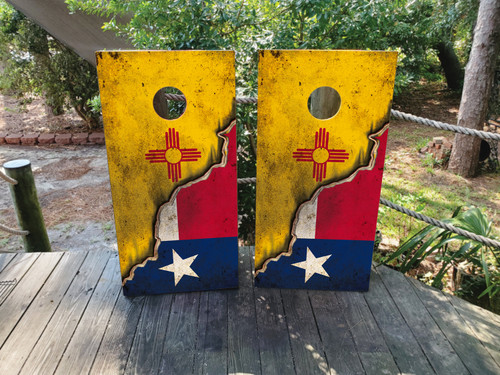 Cornhole boards featuring a distressed texas flag on bottom and a new mexico flag on the top