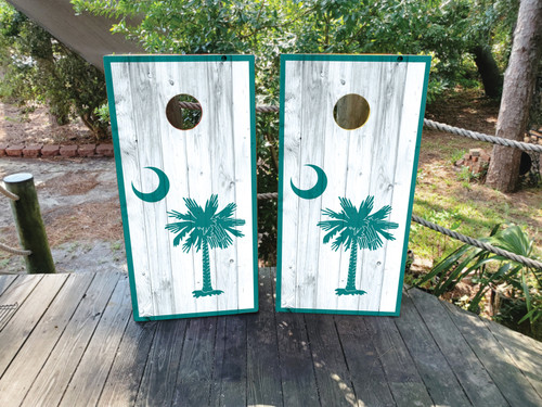 White washed, barn wood cornhole boards with the SC palm tree and crescent moon